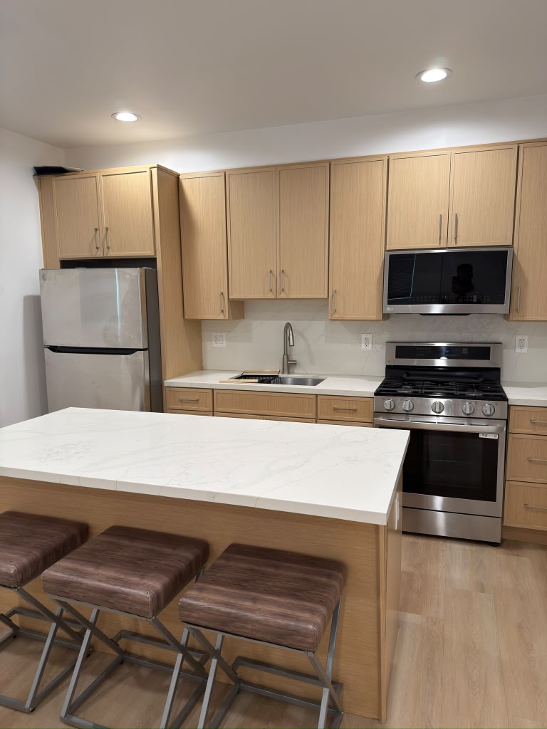 Finished Encino garage conversion with a full kitchen and island